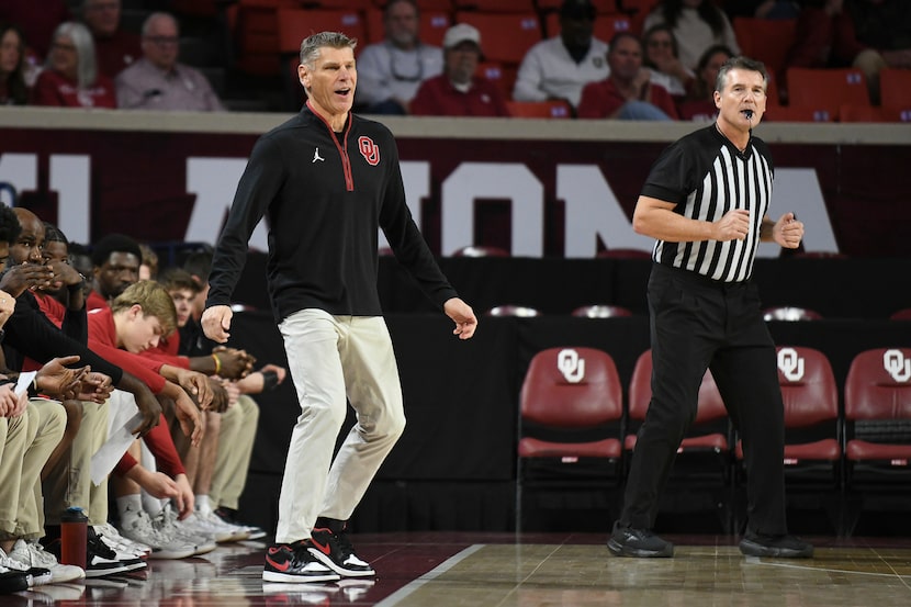 Oklahoma head coach Porter Moser, front left, watches the first half of an NCAA college...