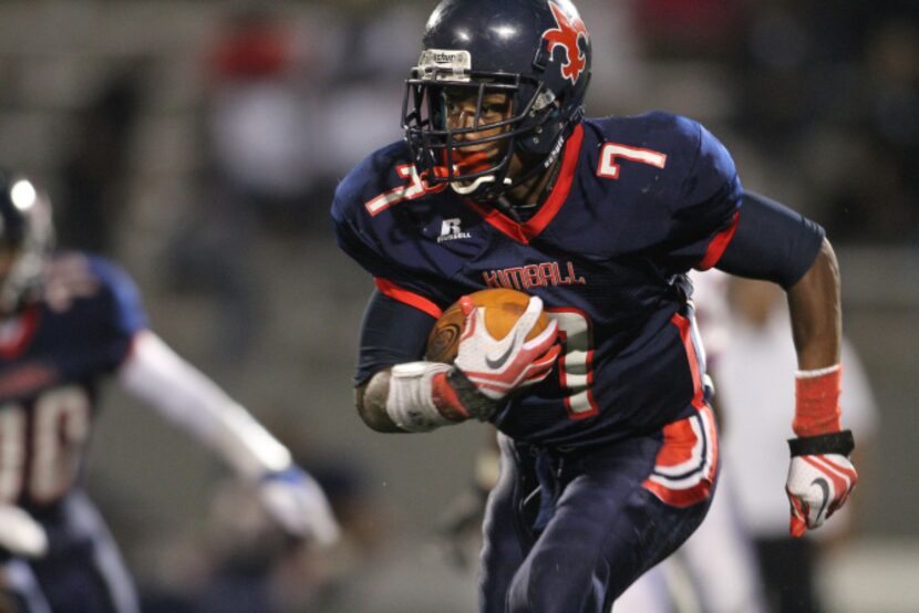 Kimball running back Teriyon Gipson (7) looks for running room against the Carter defense...