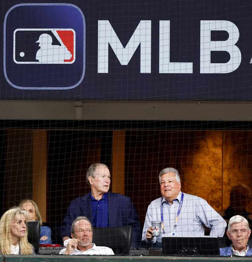 Former President George W. Bush visits with Texas Rangers president, business operations and...