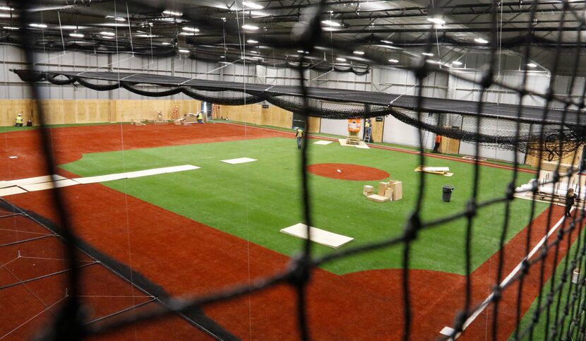 Workers continue construction of the  Adrian Beltre Infield in the The Globe Life Training...