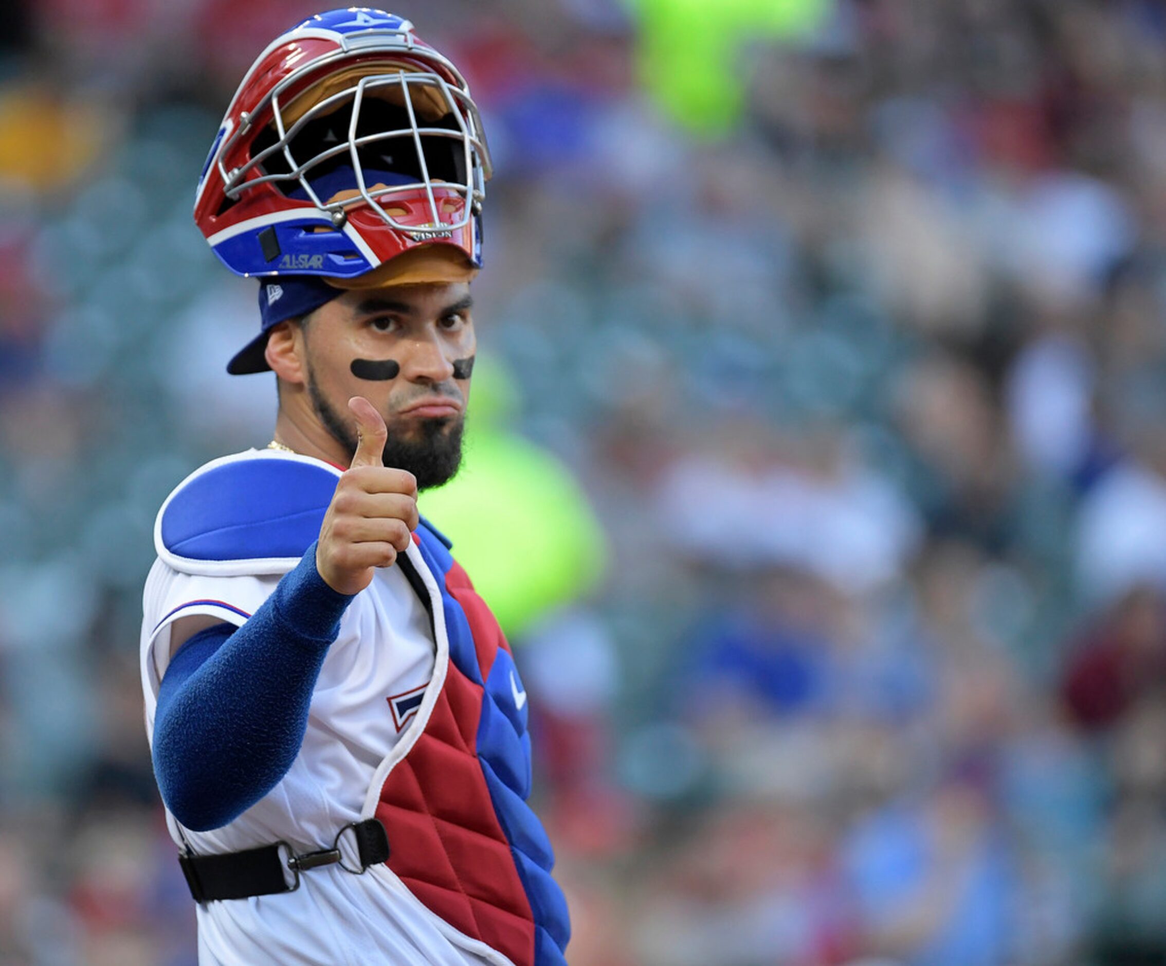 Texas Rangers catcher Robinson Chirinos (61) communicates with manager Jeff Banister (28)...