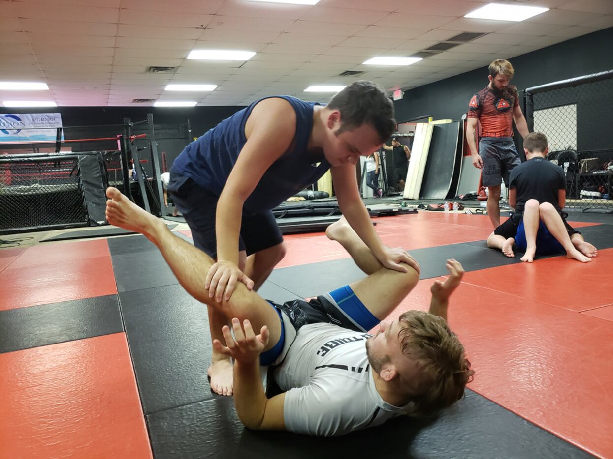 Dylan Miller (top) practices a jiu-jitsu drill on Levi Mowles at Fitness Fight Factory in...