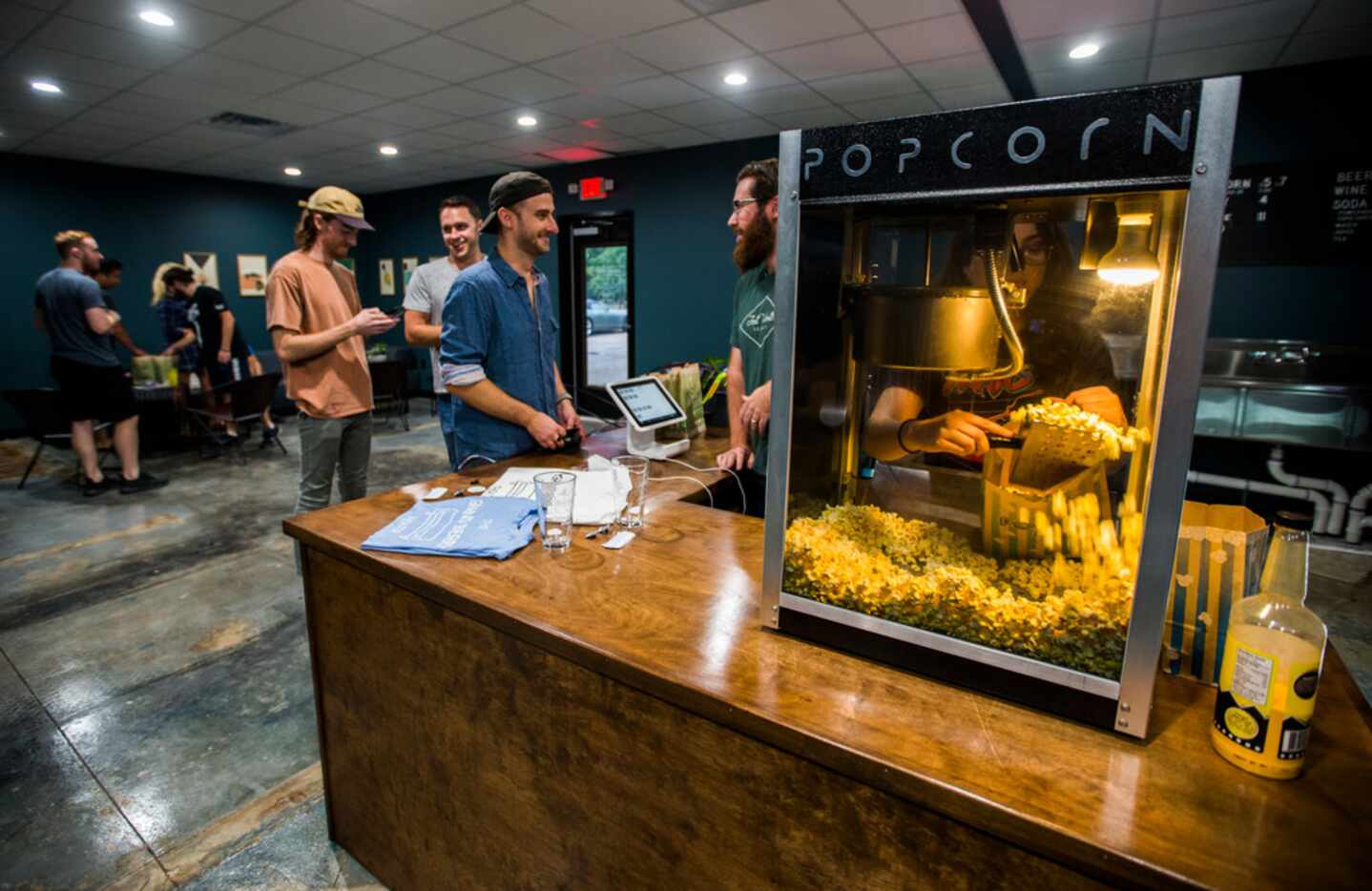 Founder Jimmy Sweeny, center, helps customers at the snack bar at The Grand Berry Theater, a...