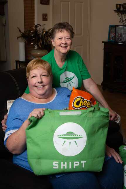 Sharon Fillner (left) and Deb Gardner, who works for the online grocery app Shipt, pose for...