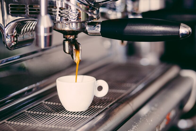 Professional coffee machine making espresso in a cafe