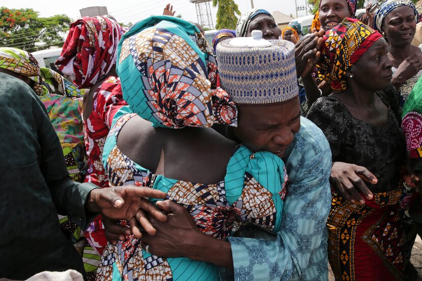 A father is reunited with one of the released Chibok girls in Abuja, more than three years...