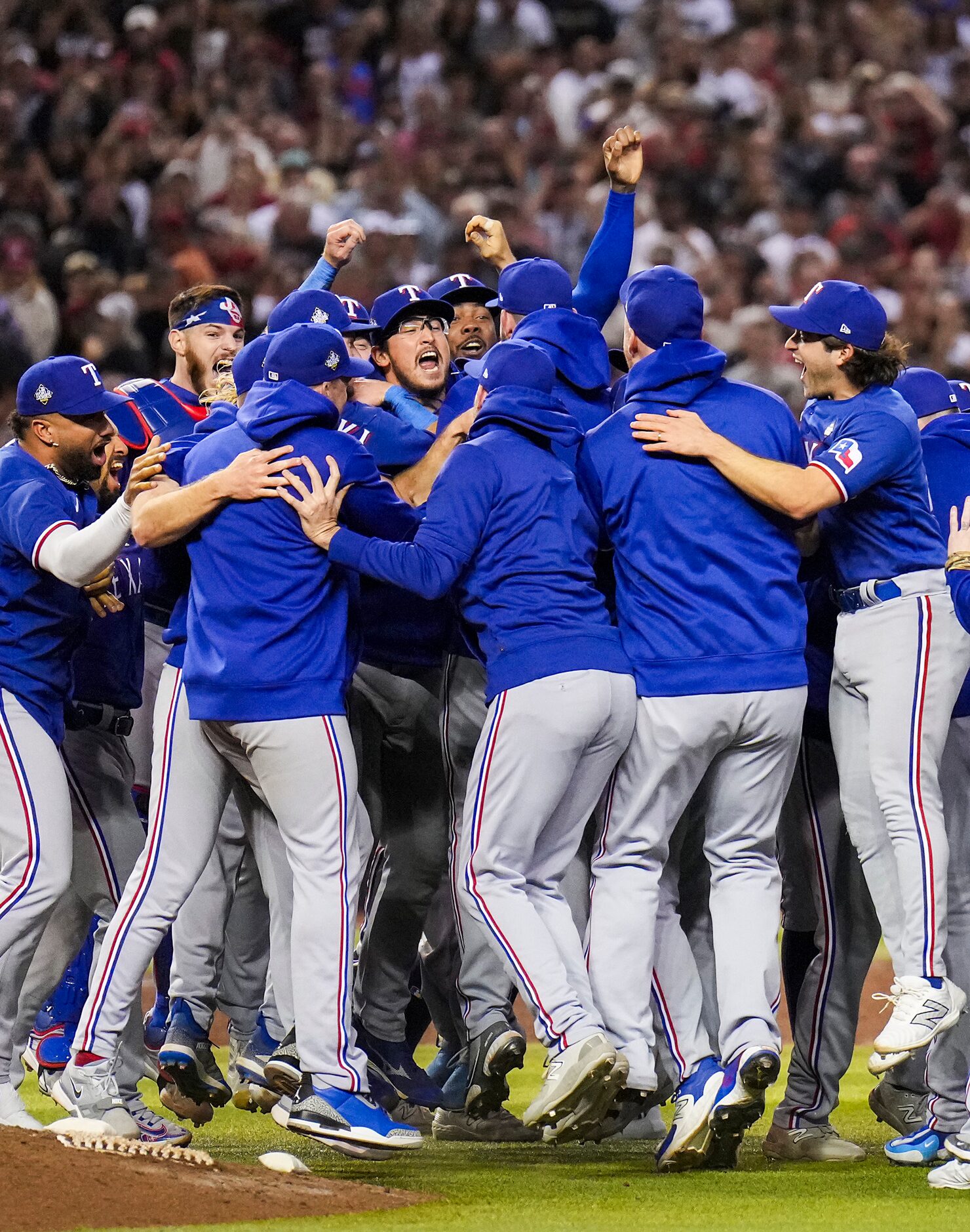 The Texas Rangers players celebrate the final out of a 5-0 victory over the Arizona...