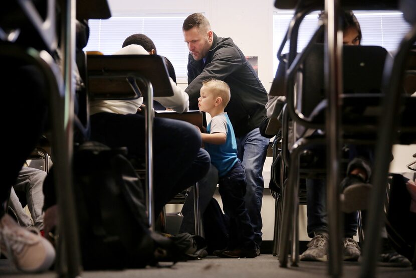 Plano East High School mathematics teacher Gary Don Moore instructs students as his son Trey...