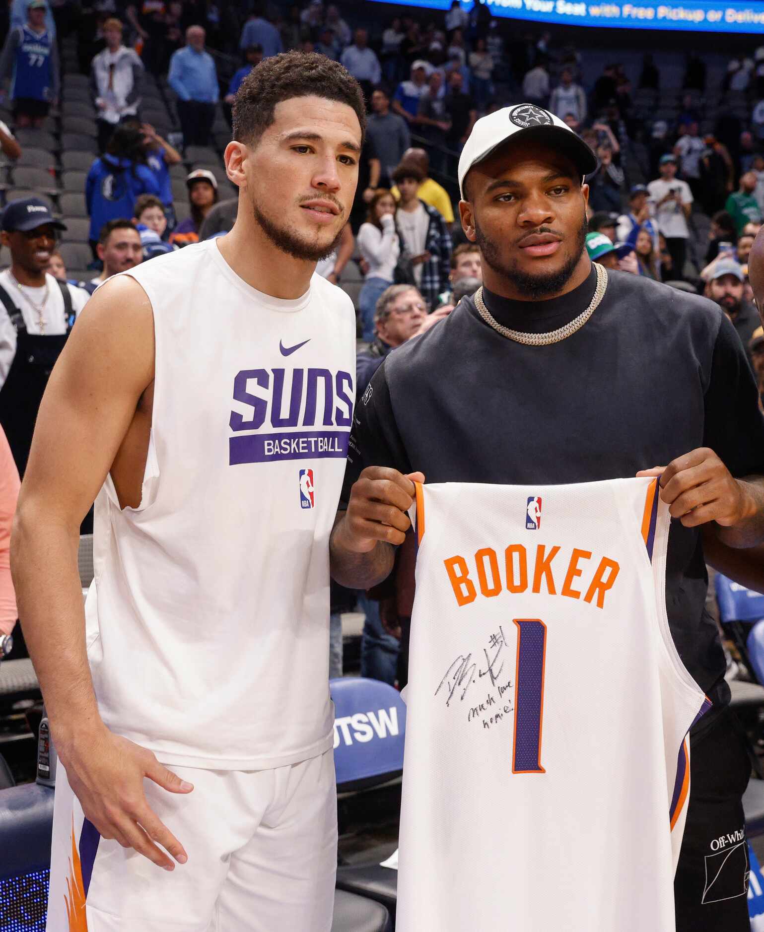 Phoenix Suns guard Devin Booker (1) poses for a photo with Dallas Cowboys linebacker Micah...