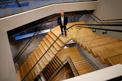 George Popstefanov stands on a landing on the staircase connecting PMG's three floors at The...