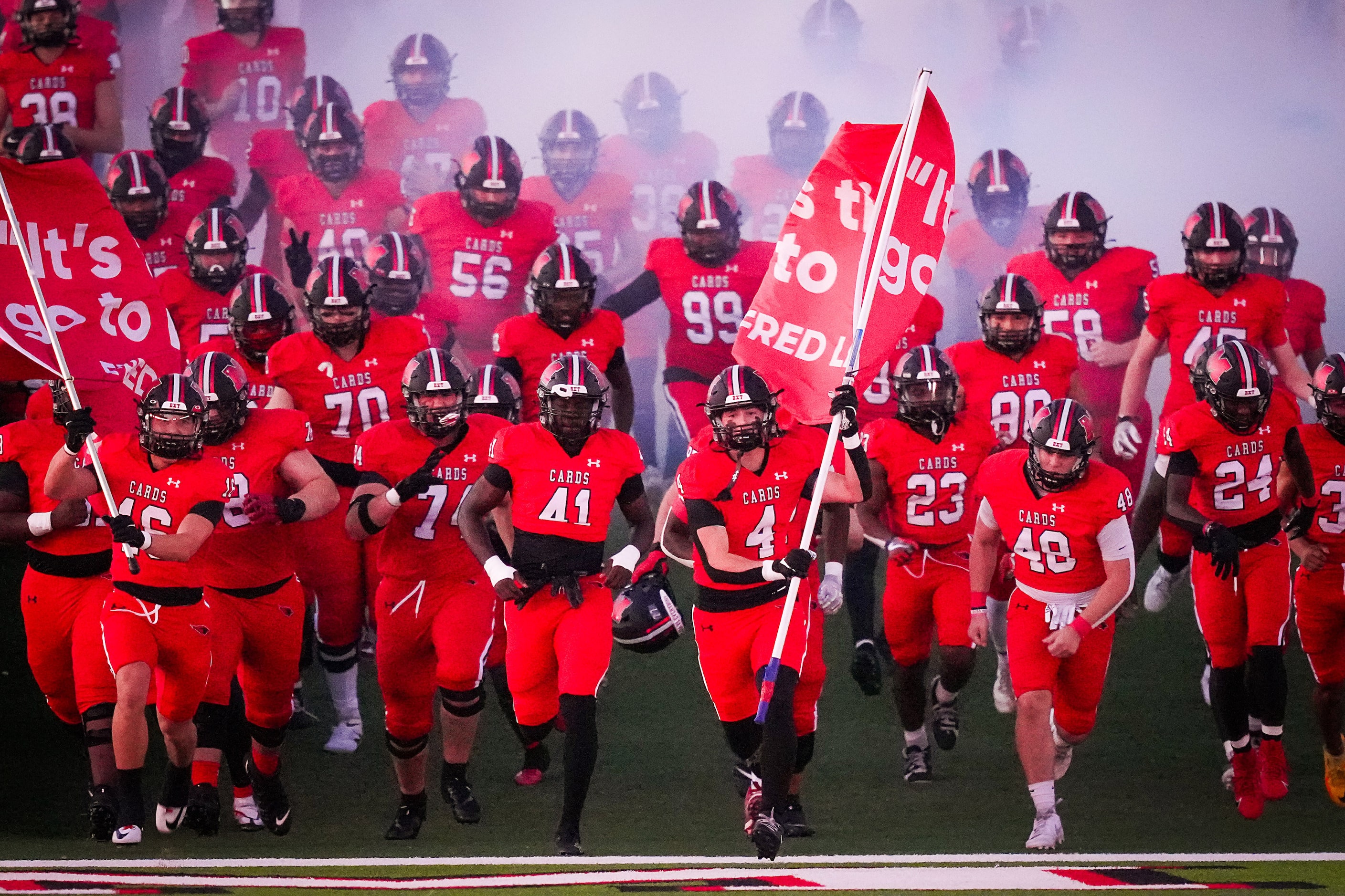 Melissa linebacker Max Corbin (4) carries a flag as he leads his team as they take the field...