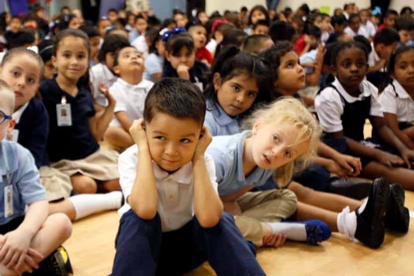 
Kindergartner Anthony Cardenas covered his ears during a student rally on the first day of...