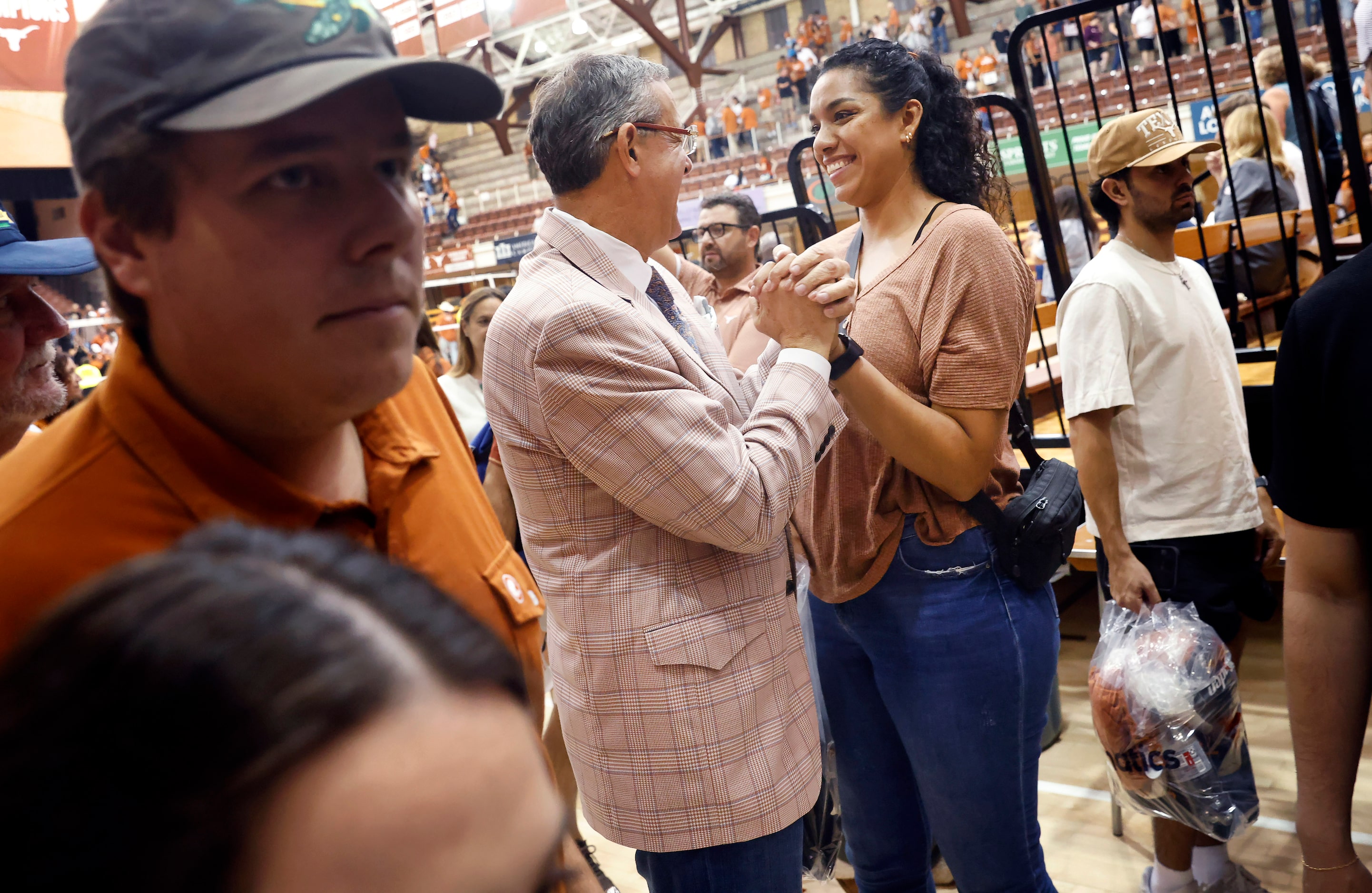 University of Texas Athletic Director Chris Del Conte (center) visits with Patti Valle, a...