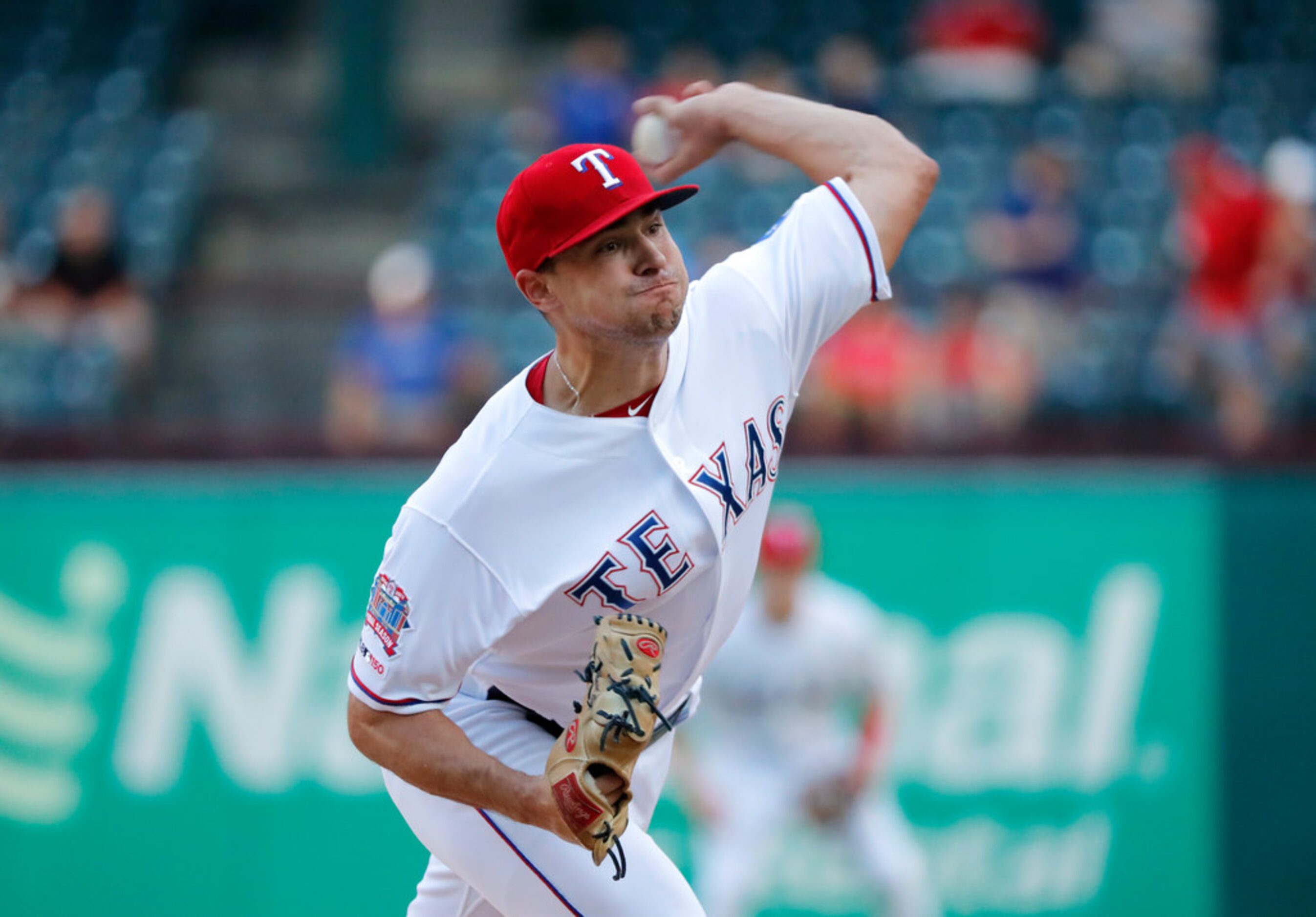 Texas Rangers starting pitcher Brock Burke throws to the Los Angeles Angels in the first...