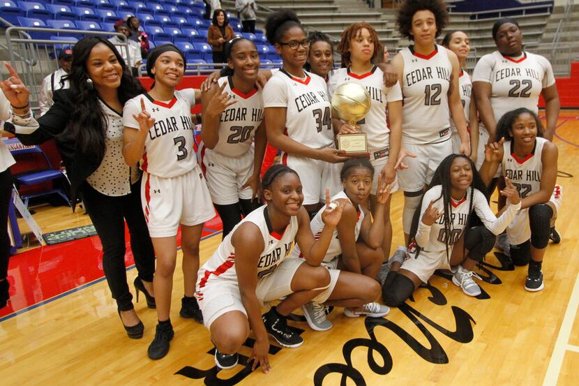 Cedar Hill coach Nicole Collins poses with her team following a 65-57 overtime victory over...