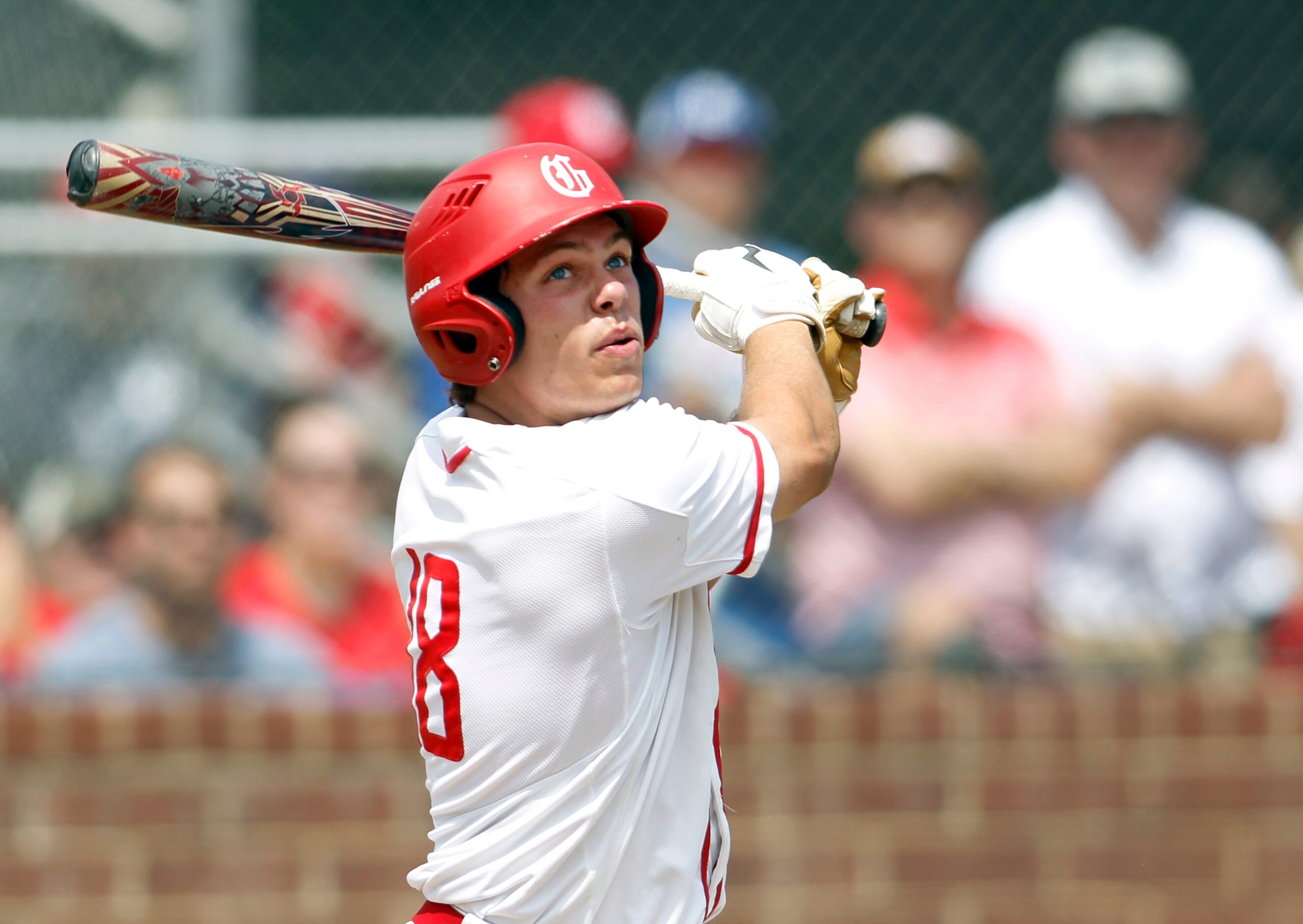 Grapevine's Jace Christian (18) watches a long fly ball head foul during game action against...