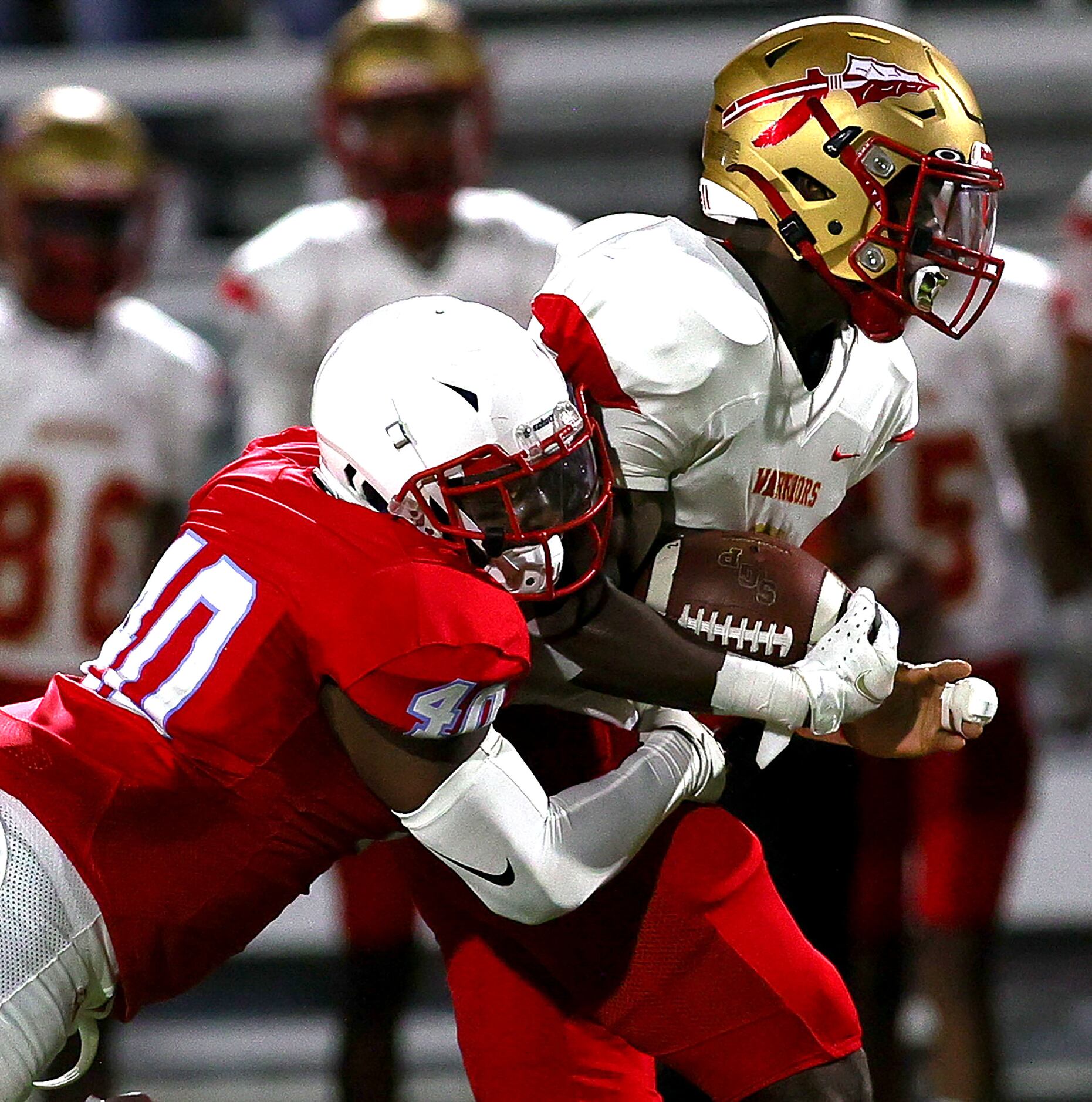 South Grand Prairie running back AJ Newberry (R) gets pulled down by Skyline linebacker...
