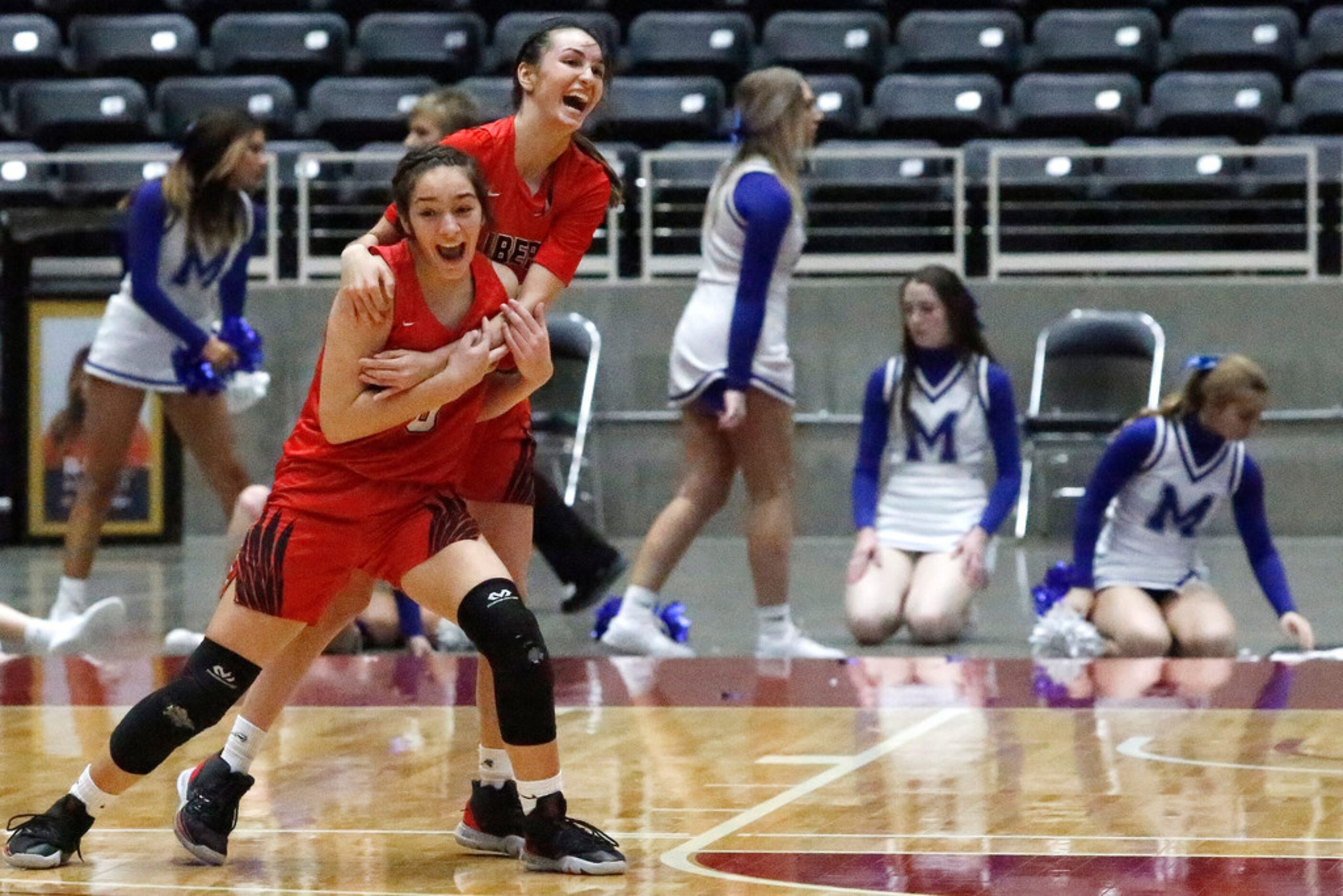 Frisco Liberty High School guard Jezelle Jolie Moreno (0) is embraced by guard Maya Jain...