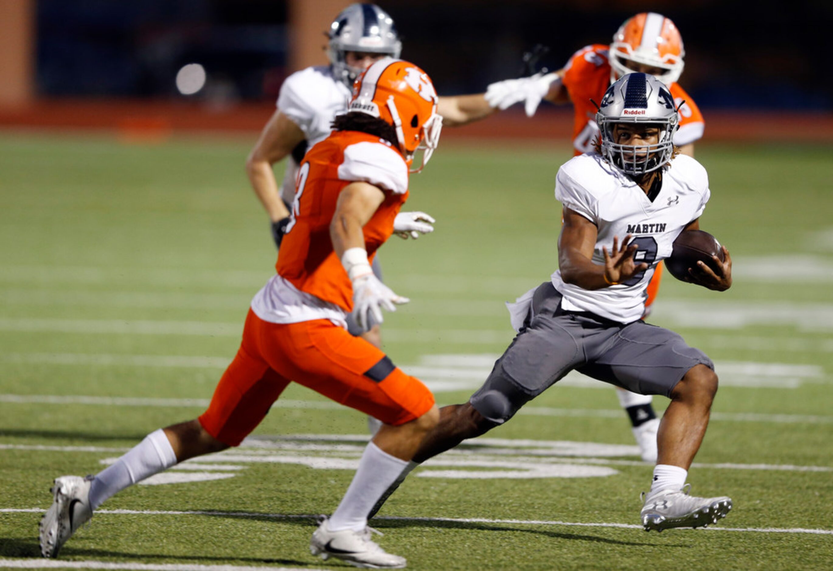 Arlington Martin's Jaden Miles (9) rushes up the field as Rockwall's Jaxon Rife (3) prepares...