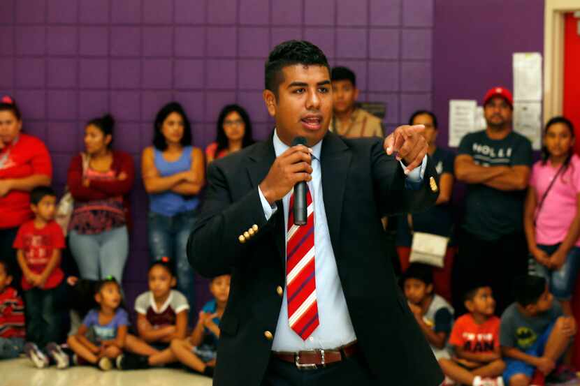Teacher Adan Gonzalez talks to parents and students at Bowie Elementary School, in Dallas,...