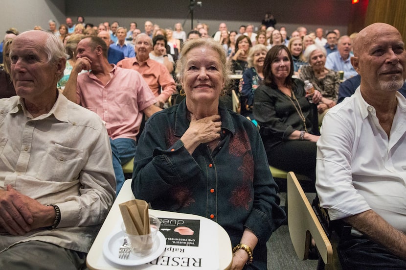 Cheryl King, the mother of Michael Meredith, center, watches herself in a preview of...