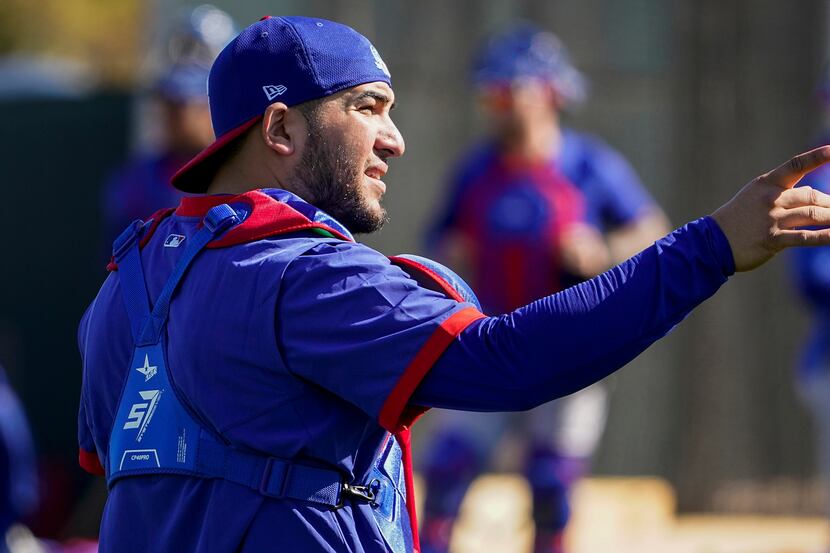 Texas Rangers catcher Jose Trevino works in the bullpen during a training workout at the...