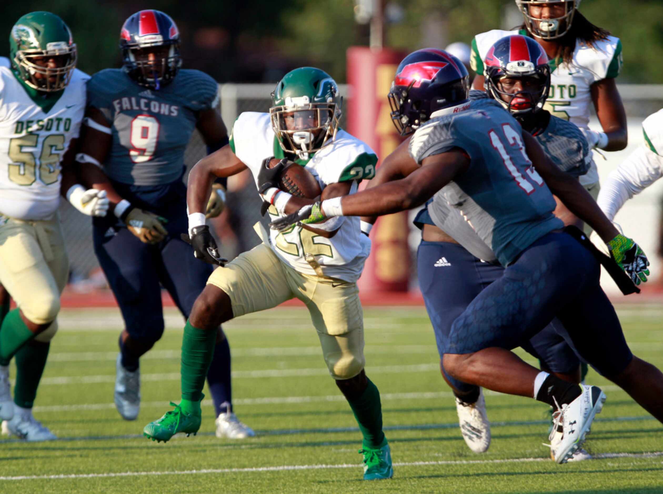 Desoto's Jyison Brown (22) picks up yardage through the Bishop Dunne defense during the...