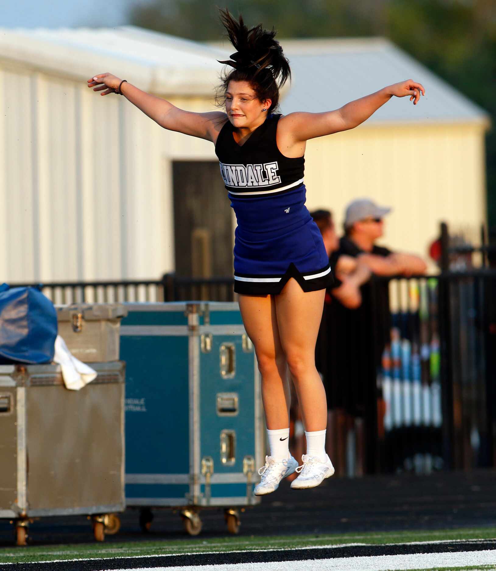 Lindale cheerleader Brittany Chavez warms up on the team sideline prior to the opening...