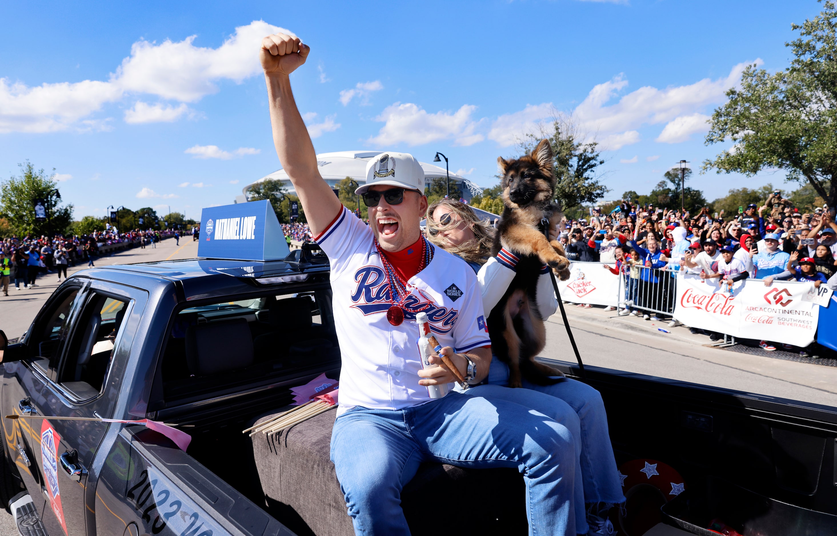 Texas Rangers first baseman Nathaniel Lowe celebrates with fans during the World Series...