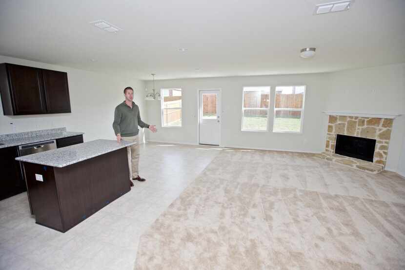 
Centex Plute Homes General Sales Manager Mike Goza show cases the kitchen and living room...