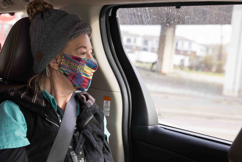 Sandy Huudang looks out the window as she rides to the temporary inclement weather shelter...