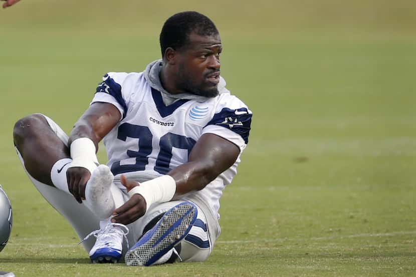 Dallas Cowboys running back Christine Michael (30) makes adjustments with his shoes during...