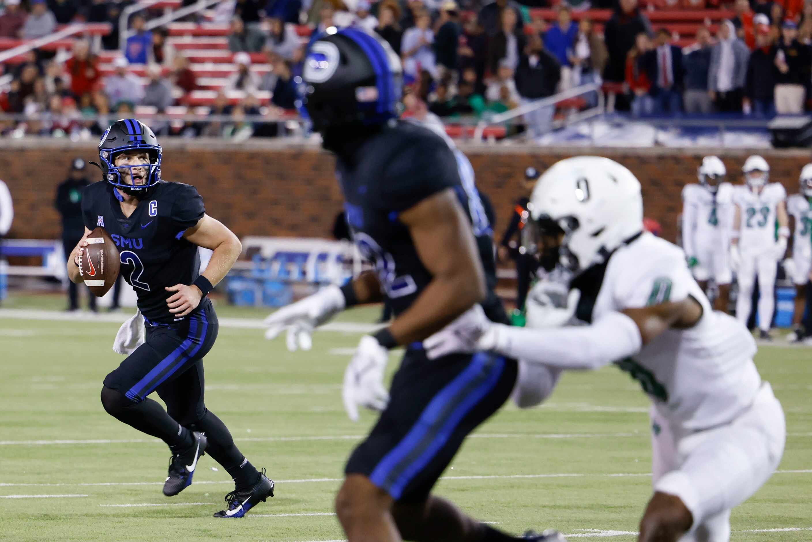 Southern Methodist Mustangs quarterback Preston Stone runs with the ball against UNT during...