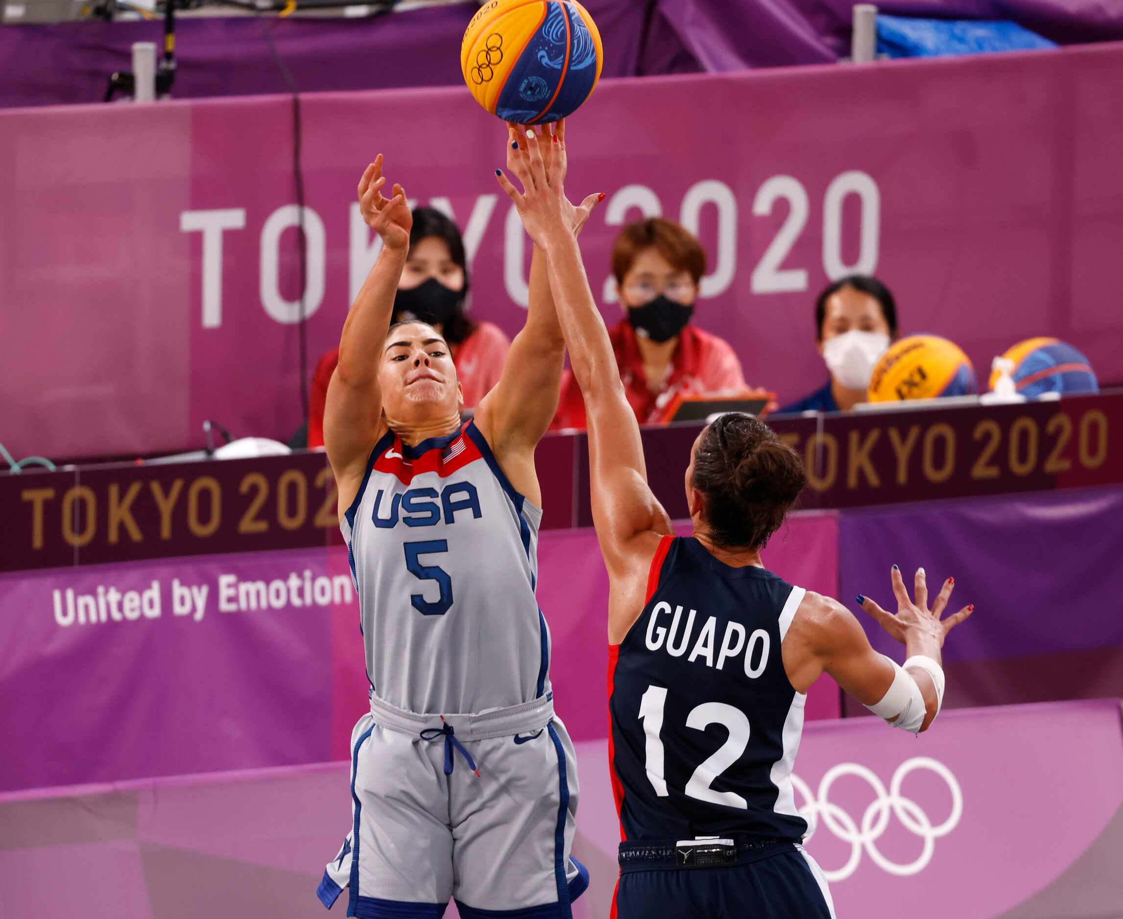 USA’s Kelsey Plum (5) shoots over the reach of France’s Laetitia Guapo (12) in a 3x3 women’s...