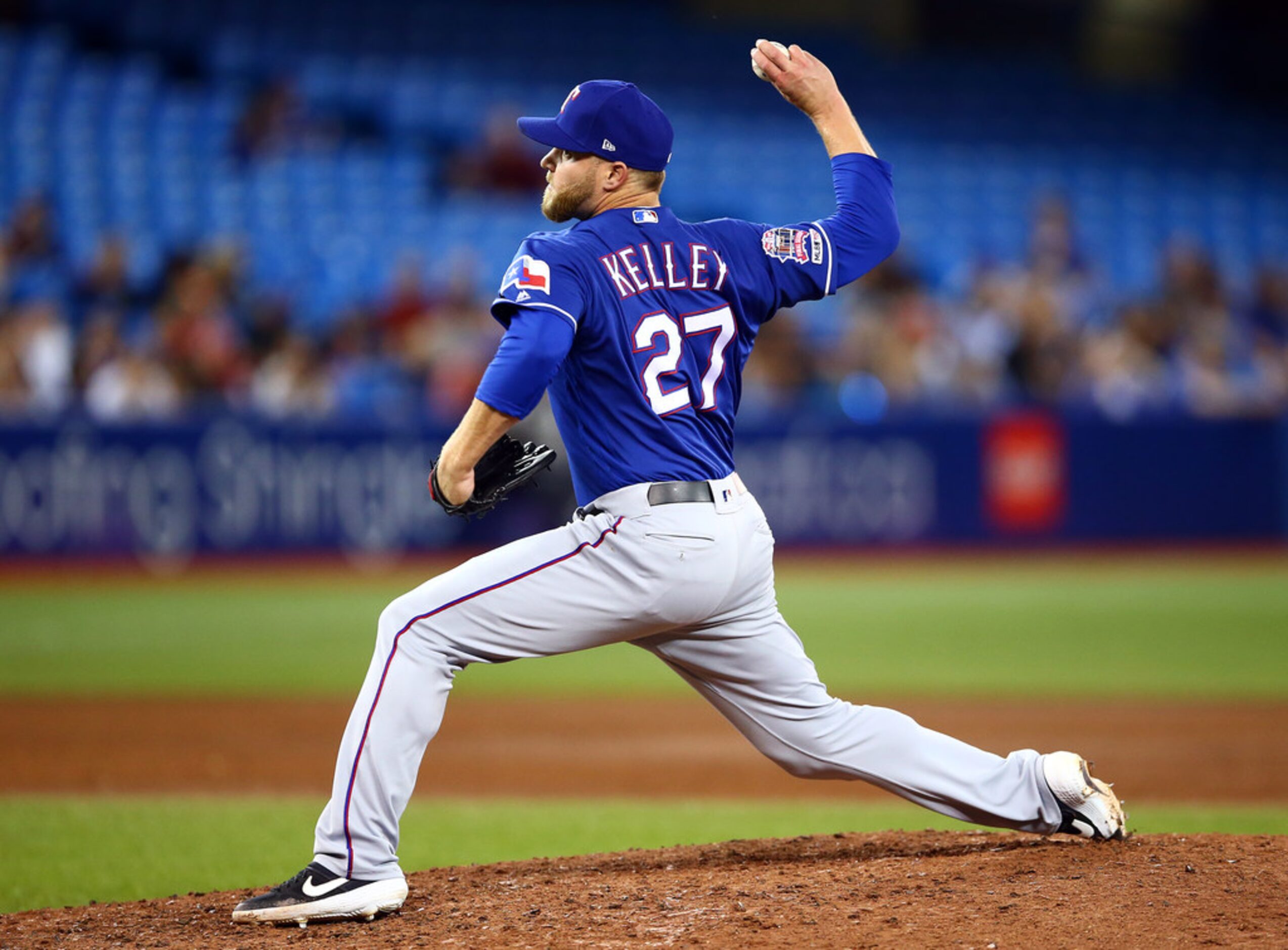 TORONTO, ON - AUGUST 13:  Shawn Kelley #27 of the Texas Rangers delivers a pitch in the...