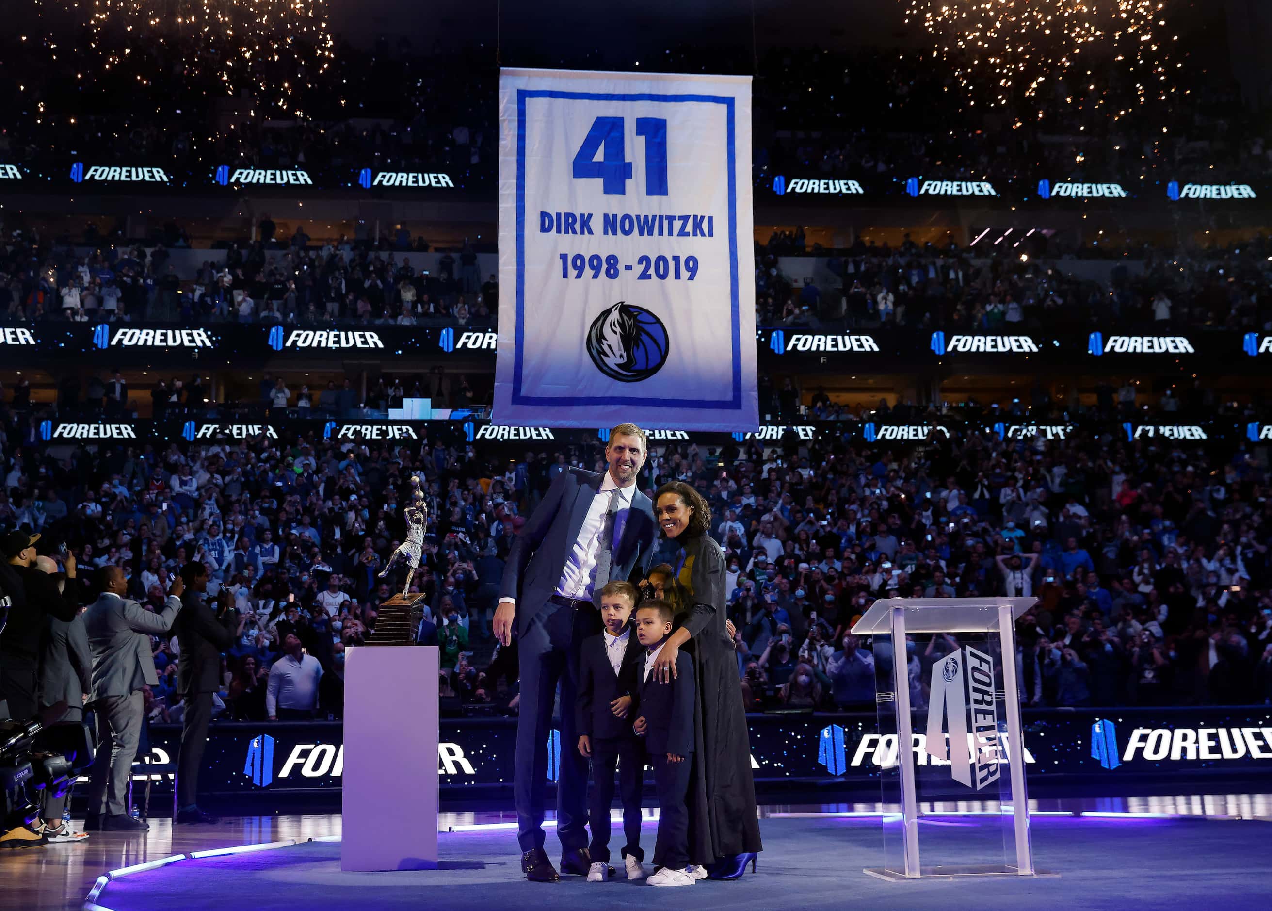 Former Dallas Mavericks All-Star Dirk Nowitzki and his family watch as his jersey is lifted...