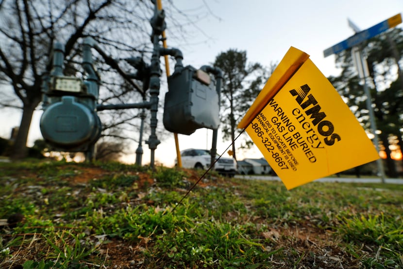 An Atmos Energy warning flag is planted along W. Glade Rd at Bill Simmons Rd in Colleyville,...