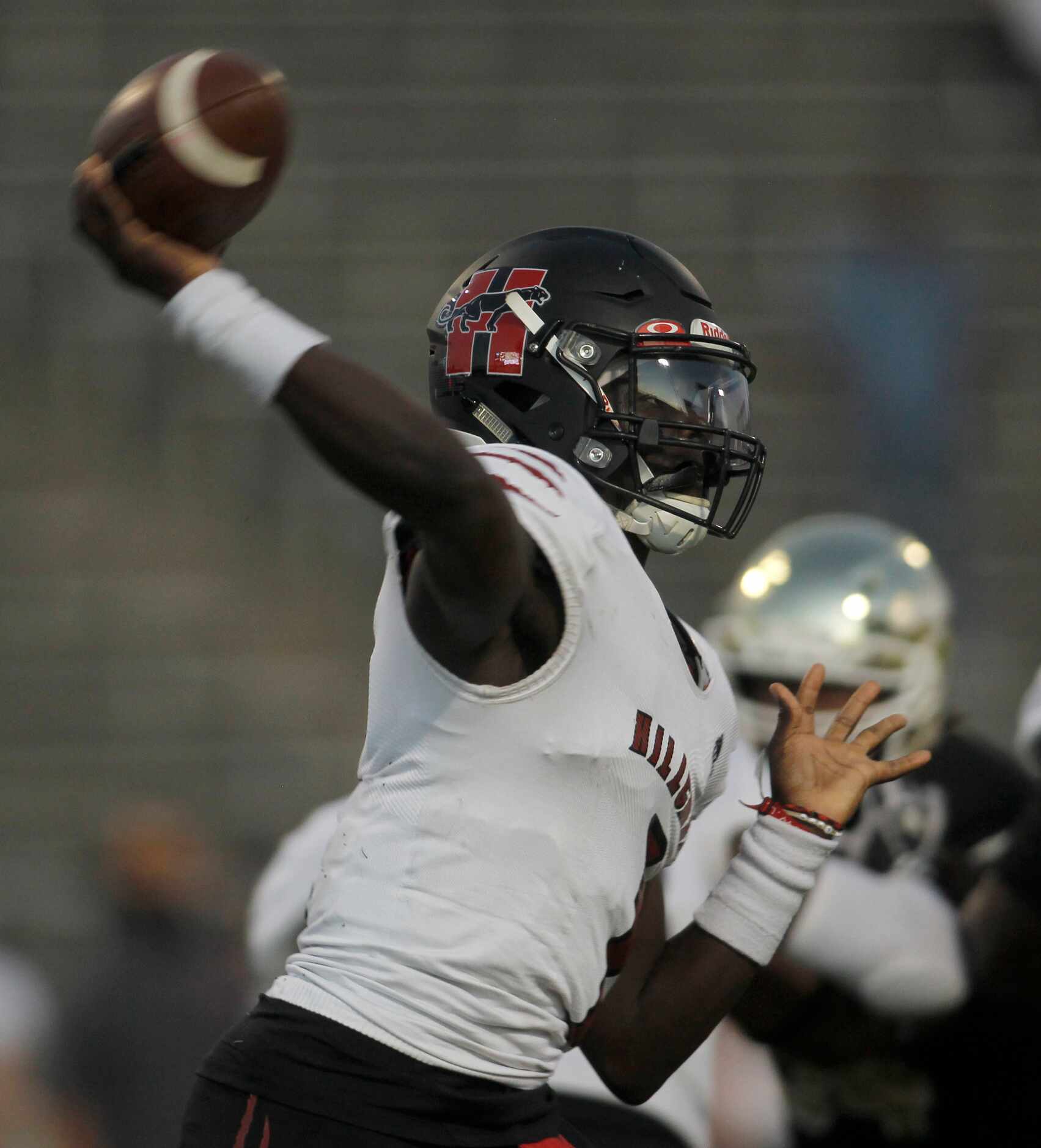 Dallas Hillcrest quarterback Carter Sido (1) passes downfield during first quarter action...