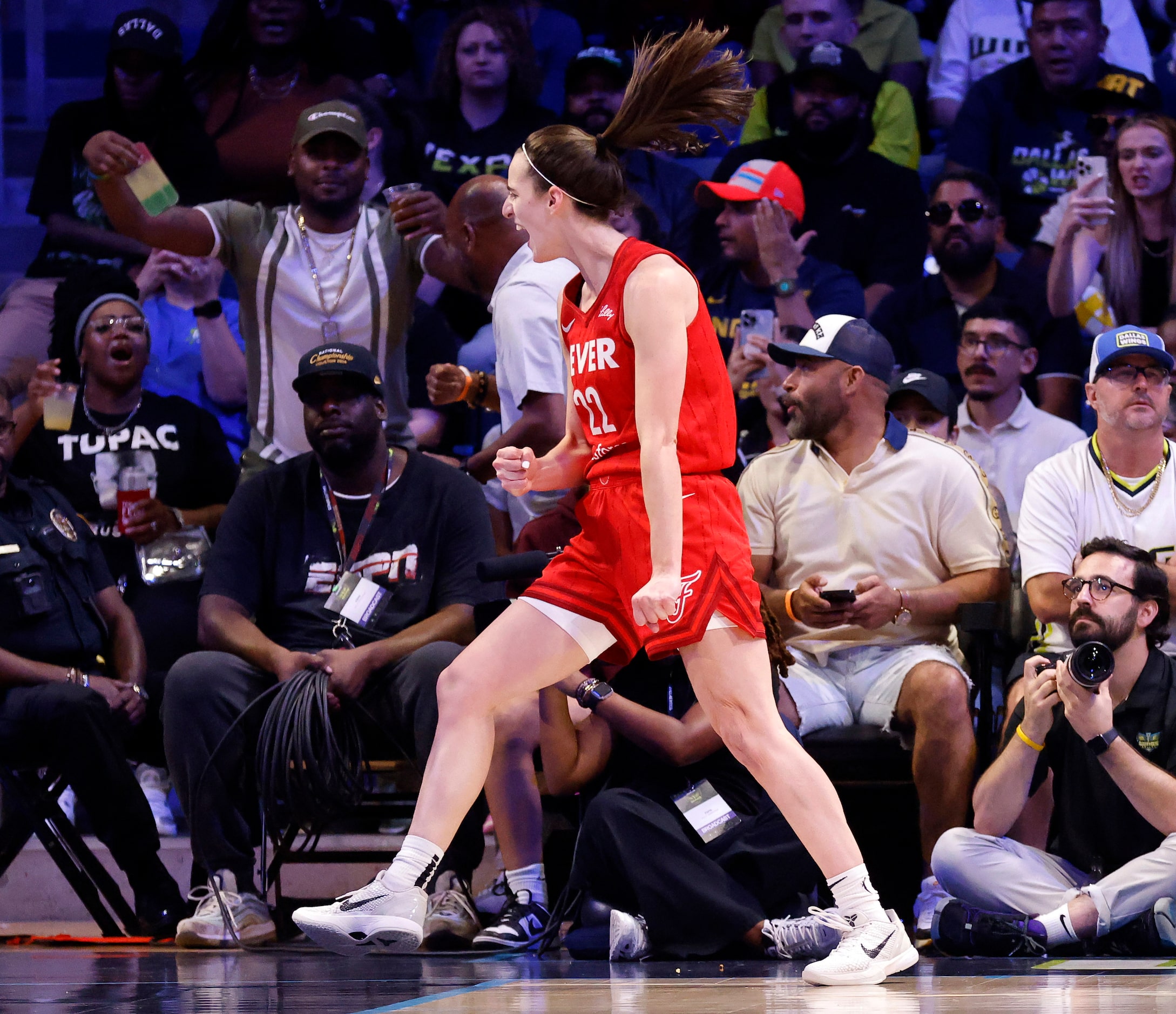 Indiana Fever guard Caitlin Clark (22) reacts after making a pass to forward NaLyssa Smith...