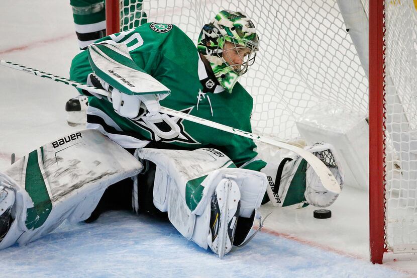 Dallas Stars goaltender Ben Bishop (30) pulls the puck out of the net after giving up the...