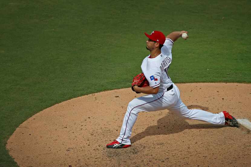 Texas Rangers starting pitcher Yu Darvish throws a pitch during the 8th inning against Los...