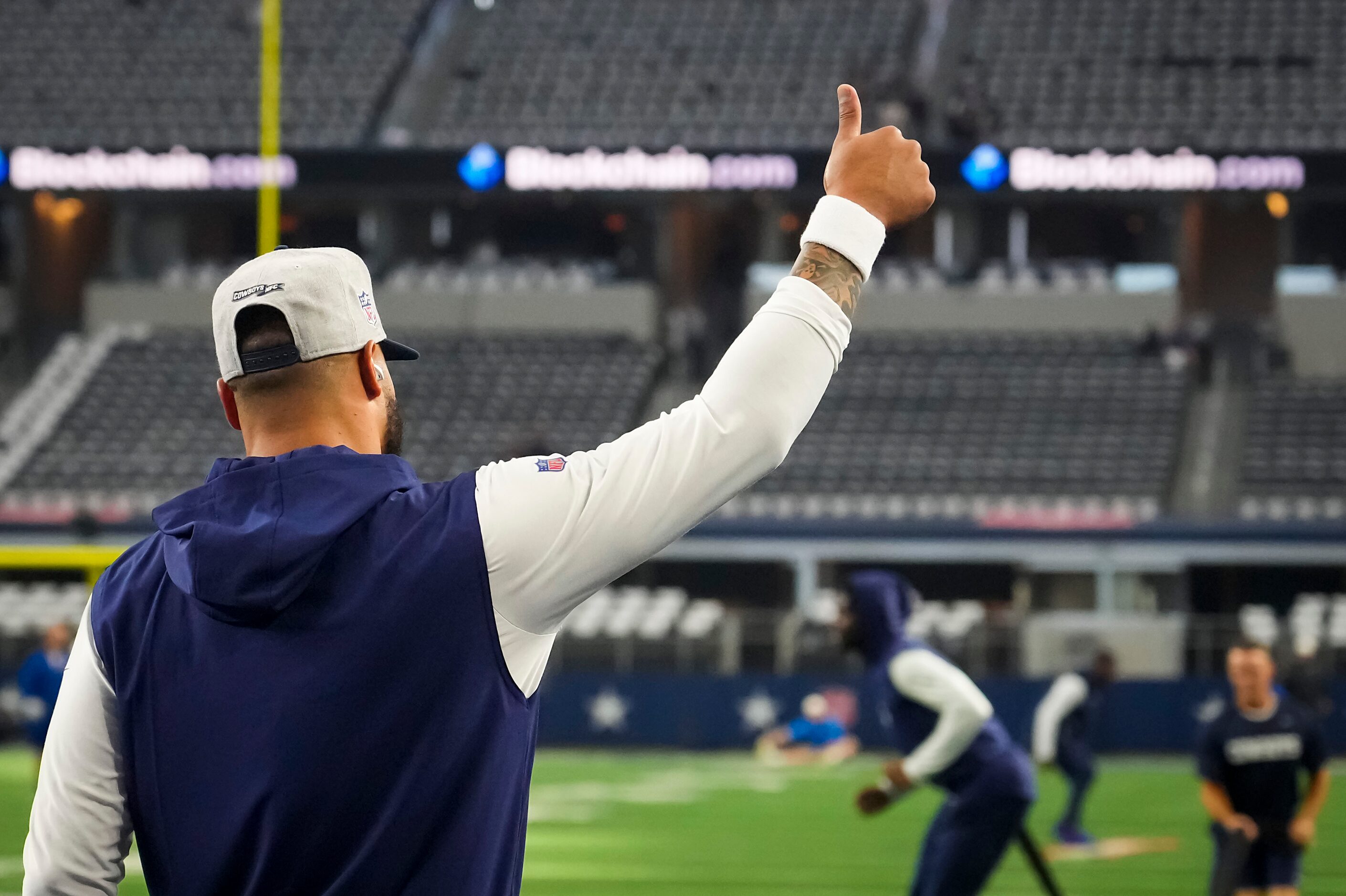 Dallas Cowboys quarterback Dak Prescott gives a thumbs up to the crowd as he warms up before...