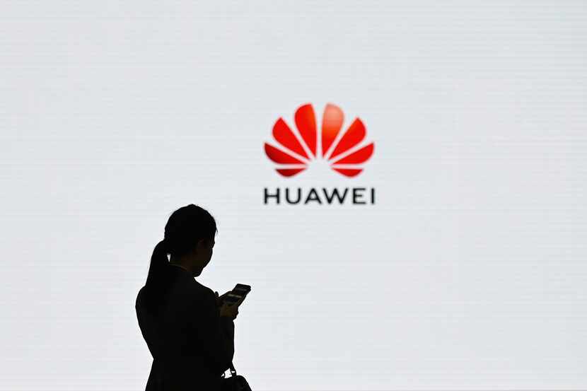 A Huawei employee used her mobile phone at the Huawei Digital Transformation Showcase in...