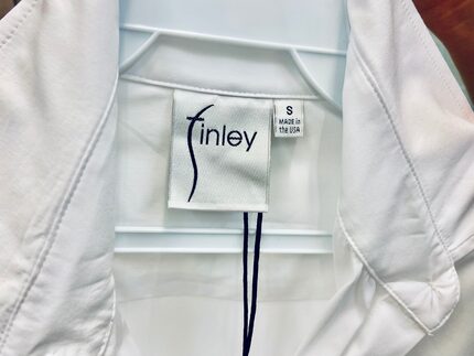 Made in the USA tag on a women's white cotton shirt by Dallas-based Finley Shirts.