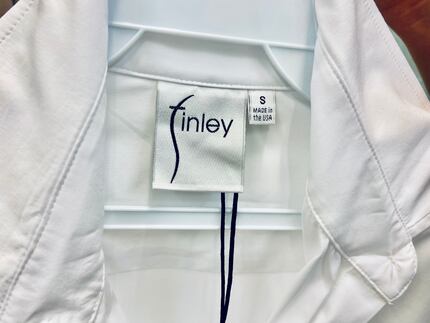 Made in the USA tag on a women's white cotton shirt by Dallas-based Finley Shirts.
