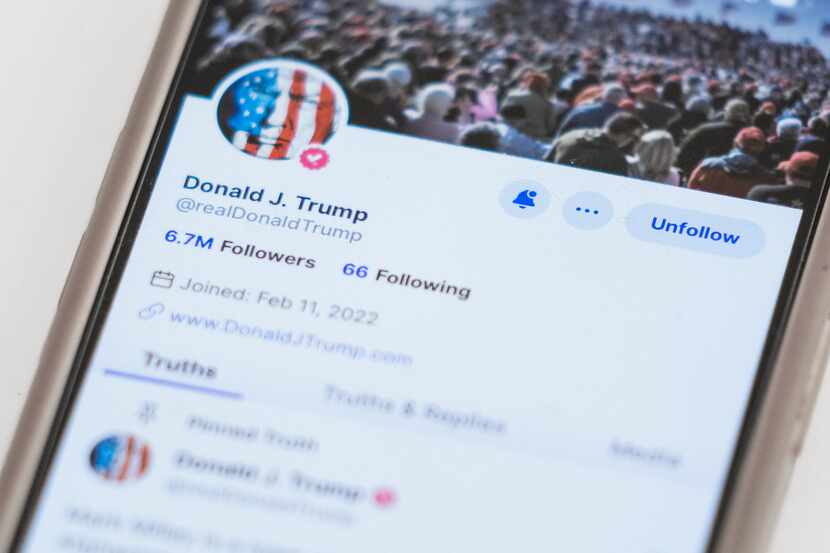 The Truth Social account for former President Donald Trump is seen on a mobile device,...