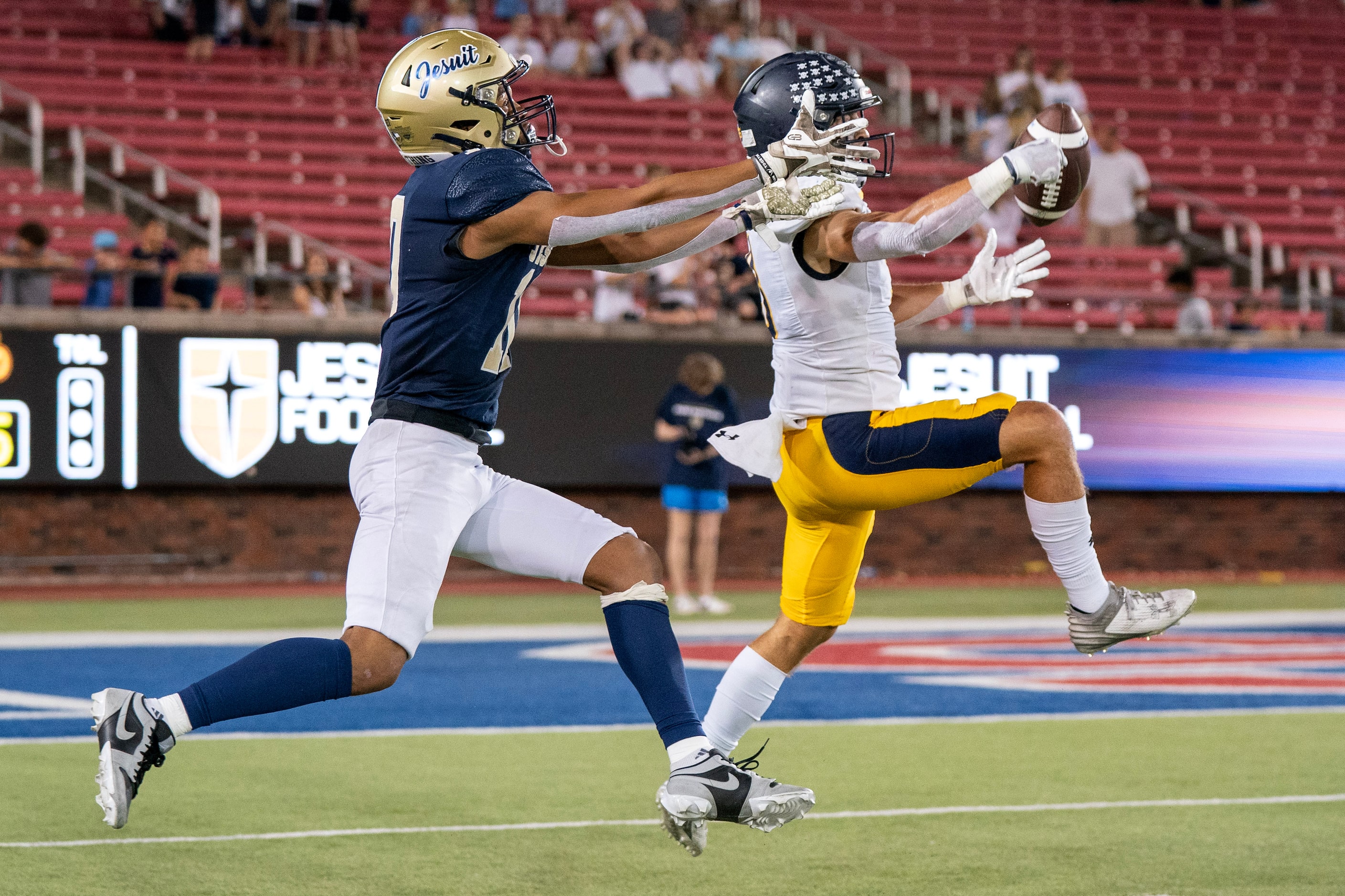 Highland Park senior cornerback Weston Giese (3) breaks up a pass intended for Jesuit senior...