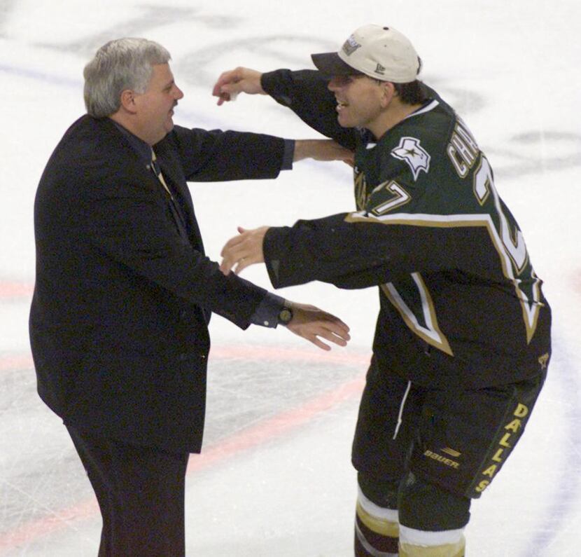 6/19/99 - Stanley Cup Finals, Game 6 - Ken Hitchcock hugs Shawn Chambers after Game 6 of the...