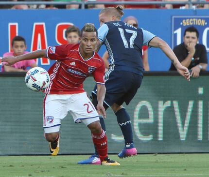 FC Dallas' Michael Barrios (21) maintains focus after turning around Vancouver Whitecaps FcC...