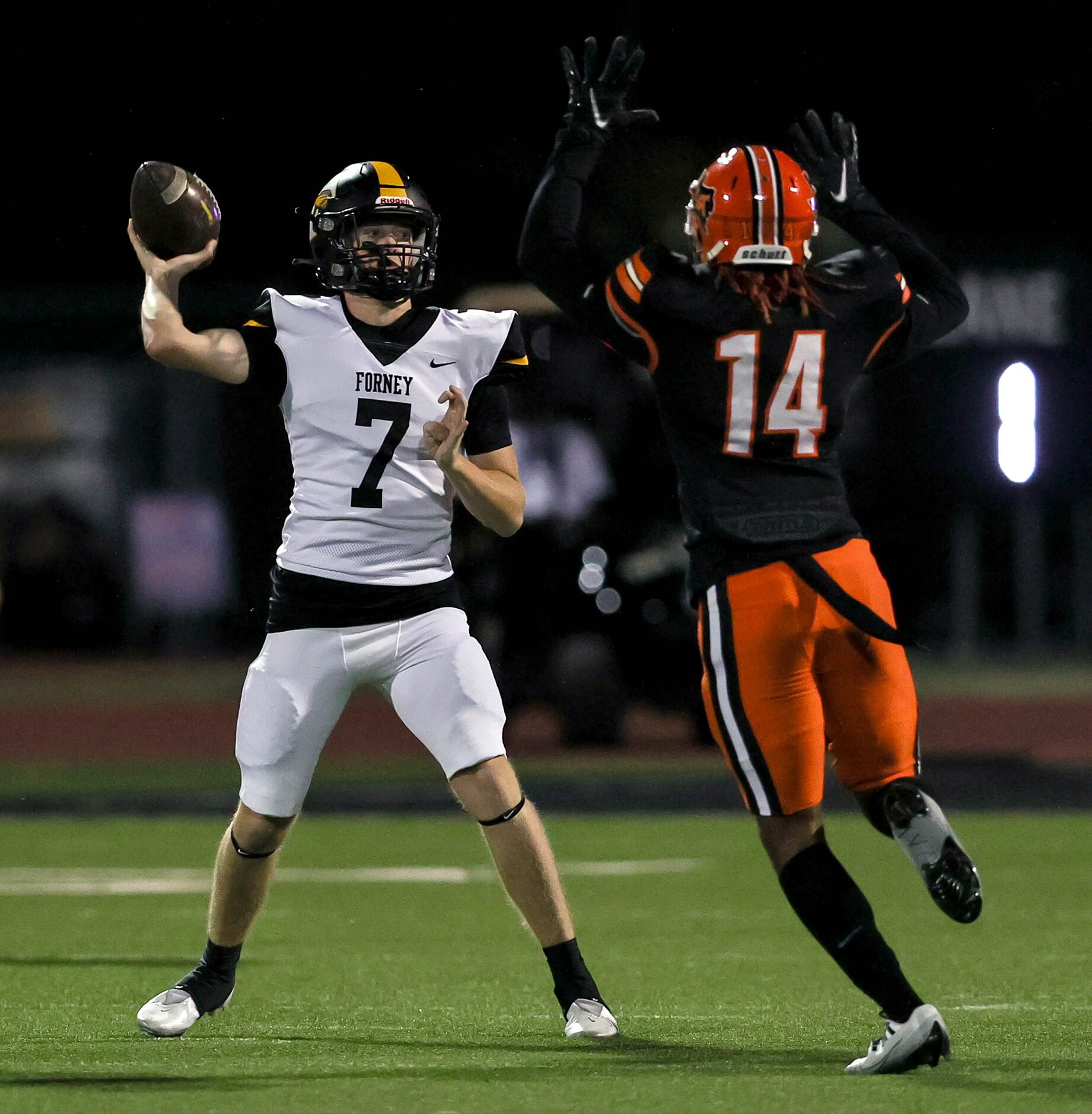 Forney quarterback Brent Paine (7) gets some pressure from Lancaster defensive end Claude...